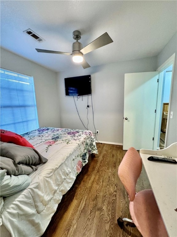 bedroom with dark hardwood / wood-style floors and ceiling fan