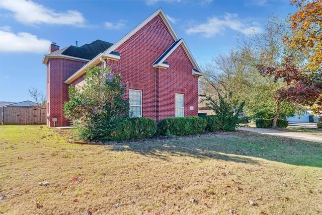 view of side of home featuring a lawn