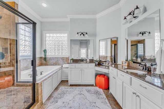 bathroom with plus walk in shower, vanity, and crown molding