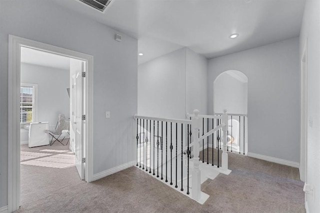 hallway with light colored carpet