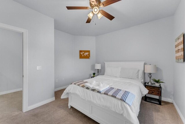 bedroom with ceiling fan and light carpet