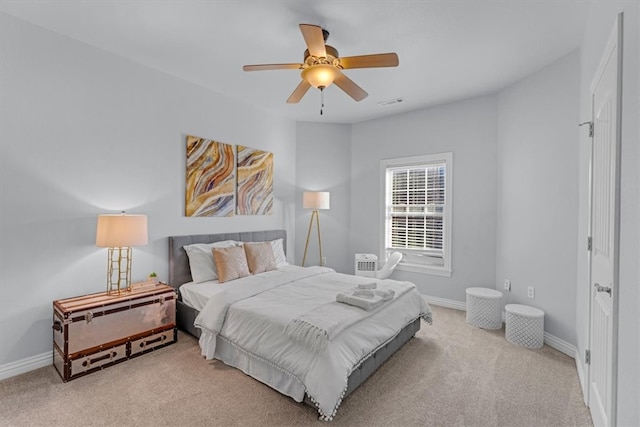 bedroom with ceiling fan and light colored carpet