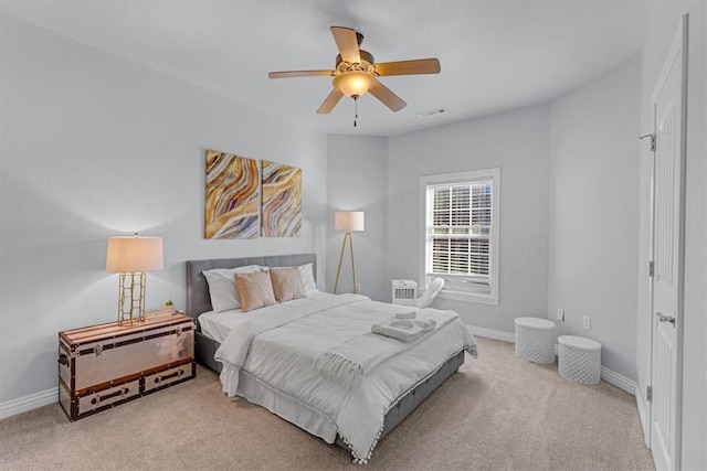 bedroom featuring light colored carpet and ceiling fan