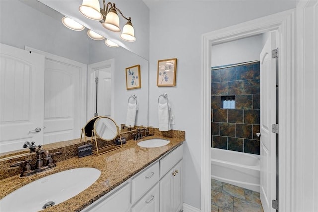 bathroom featuring tiled shower / bath combo, vanity, and an inviting chandelier