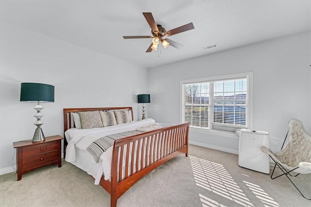 bedroom featuring light colored carpet and ceiling fan