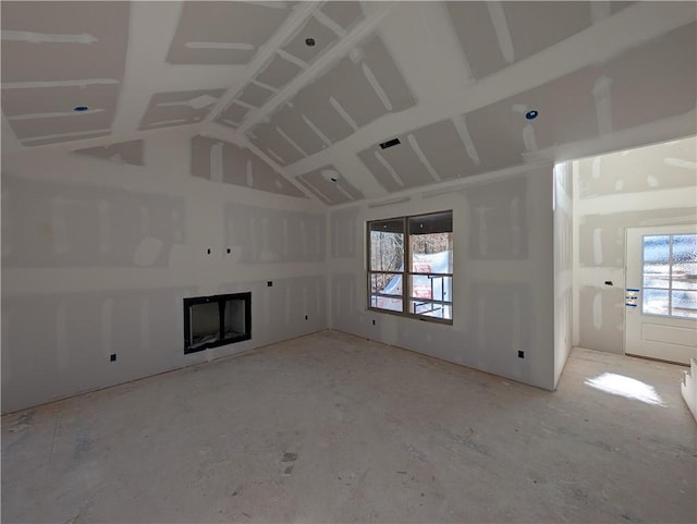 unfurnished living room with vaulted ceiling