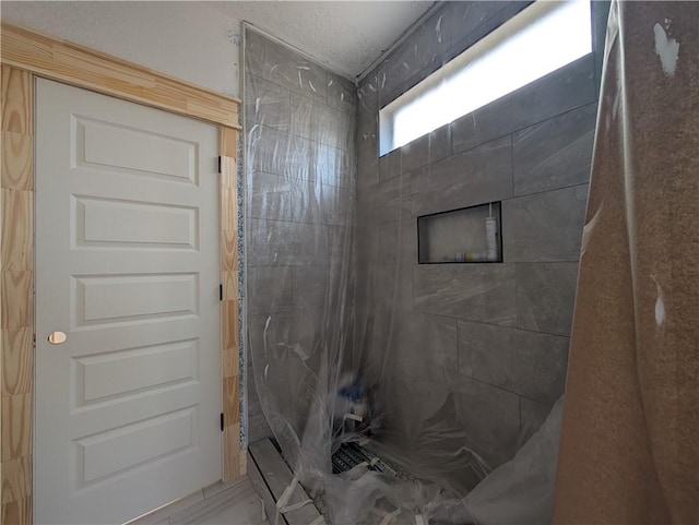 full bathroom with a tile shower