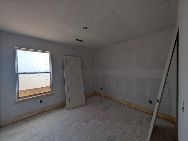 unfurnished bedroom with a textured ceiling