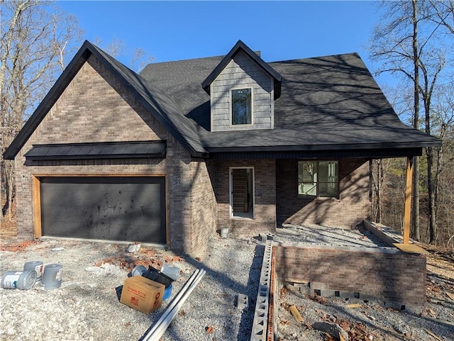 view of front of home featuring brick siding, a shingled roof, and a garage