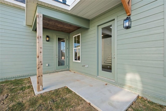 property entrance featuring a patio