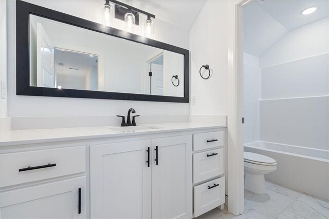 full bathroom with toilet, shower / washtub combination, vanity, and vaulted ceiling