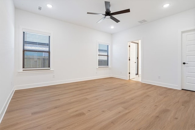 empty room featuring light wood-type flooring and ceiling fan