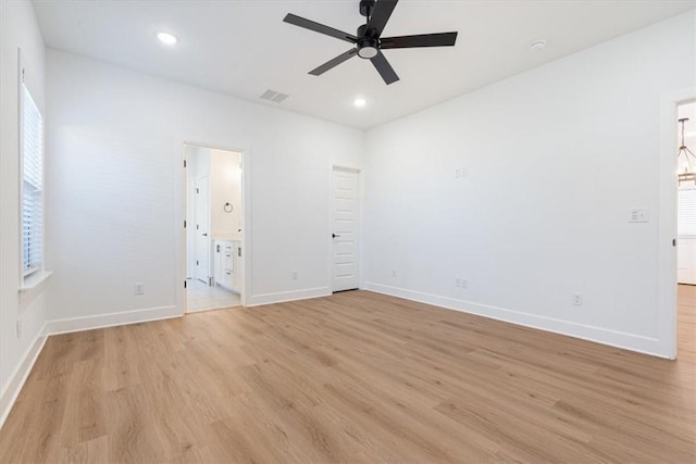 empty room with ceiling fan and light hardwood / wood-style floors