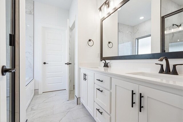 bathroom featuring vanity and a shower with shower door