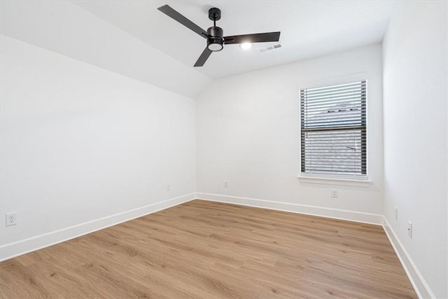 unfurnished room with ceiling fan, light wood-type flooring, and vaulted ceiling