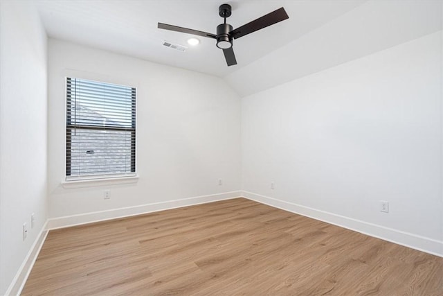 spare room featuring ceiling fan, light hardwood / wood-style flooring, and vaulted ceiling