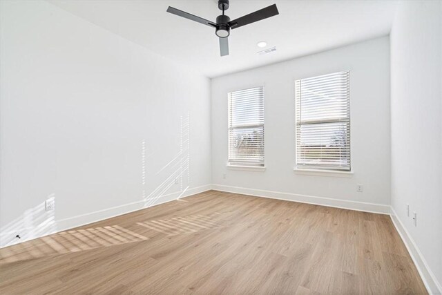 unfurnished room with light wood-type flooring and ceiling fan