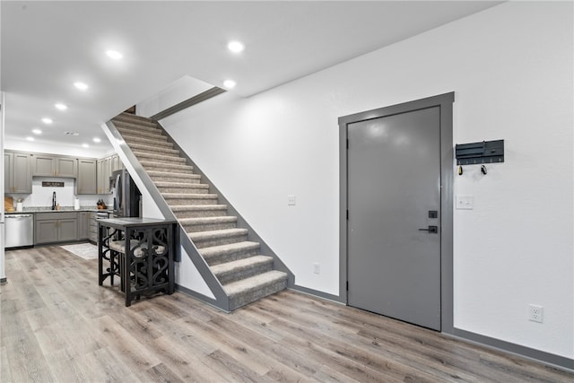 foyer featuring sink and light hardwood / wood-style flooring