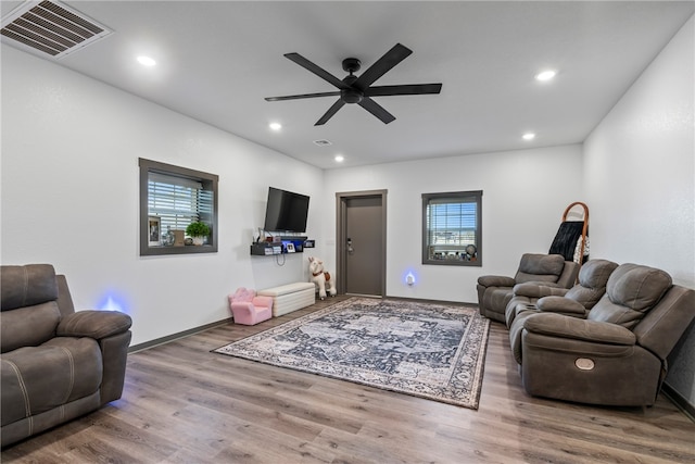 living room featuring ceiling fan and hardwood / wood-style floors