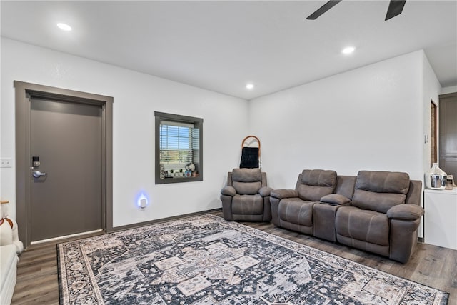 living room with ceiling fan and dark hardwood / wood-style flooring