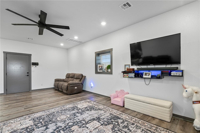 living room with hardwood / wood-style flooring and ceiling fan