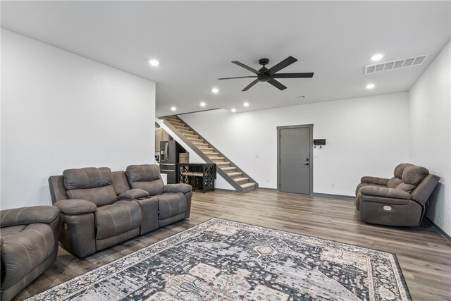 living room with hardwood / wood-style flooring and ceiling fan