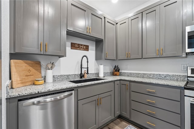 kitchen featuring gray cabinetry, sink, and stainless steel appliances