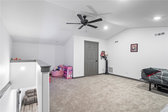 playroom with ceiling fan, light colored carpet, and vaulted ceiling