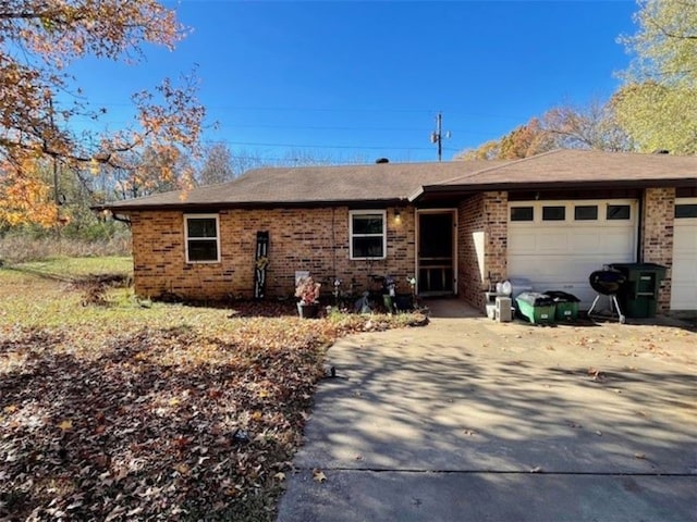 659 Genevieve Ave, Fayetteville, AR 72704 - view of front of house with brick siding, an attached garage, concrete driveway, and a shingled roof