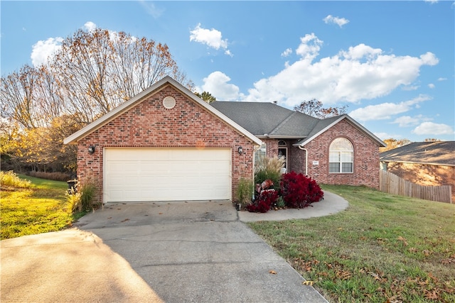 view of front of house featuring a front yard and a garage