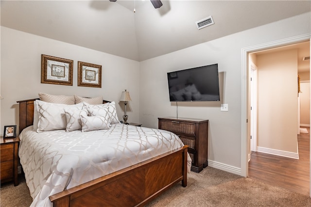 bedroom with light hardwood / wood-style floors, ceiling fan, and lofted ceiling