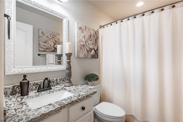 bathroom with vanity, toilet, and walk in shower