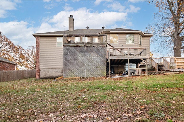 back of property with a lawn and a wooden deck