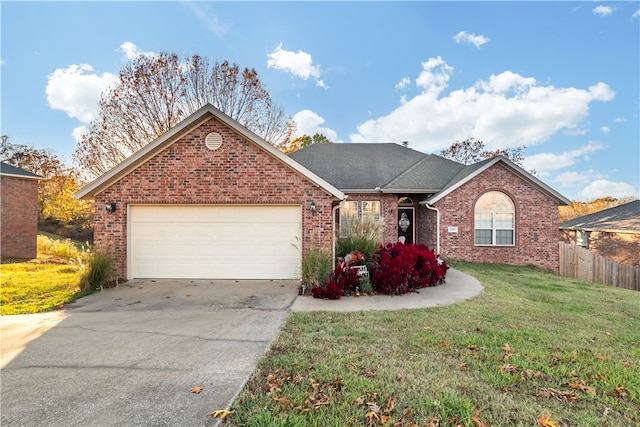 view of front of property with a garage and a front lawn