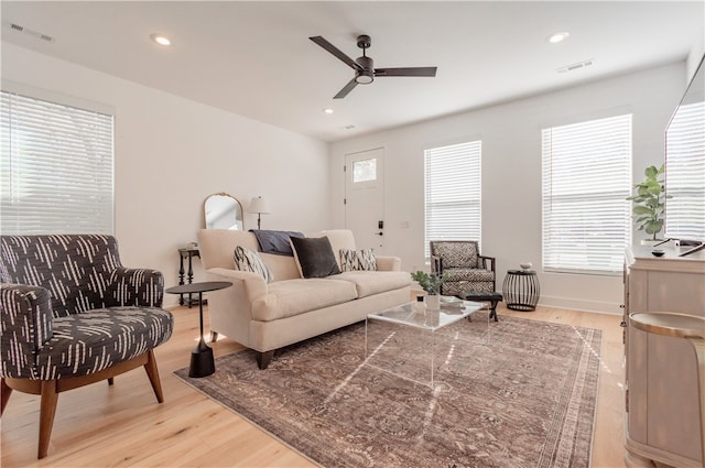 living room featuring ceiling fan and light hardwood / wood-style flooring