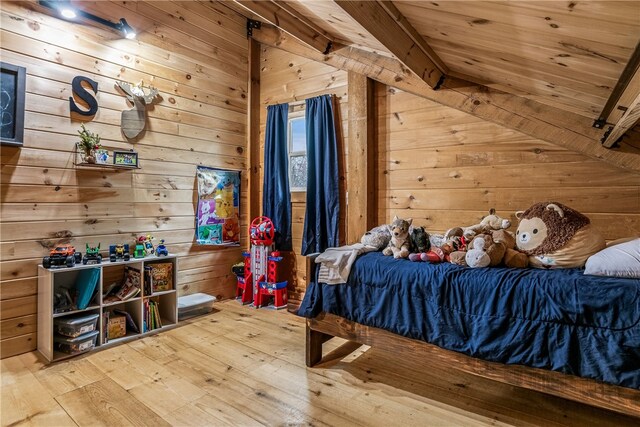 bedroom with wood ceiling, hardwood / wood-style flooring, and wooden walls