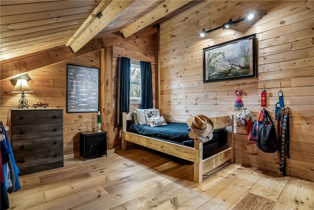 bedroom featuring light hardwood / wood-style flooring, wood ceiling, beam ceiling, and wood walls