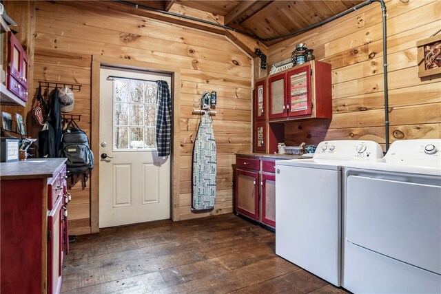 laundry room featuring separate washer and dryer, wood ceiling, cabinets, dark hardwood / wood-style floors, and wood walls