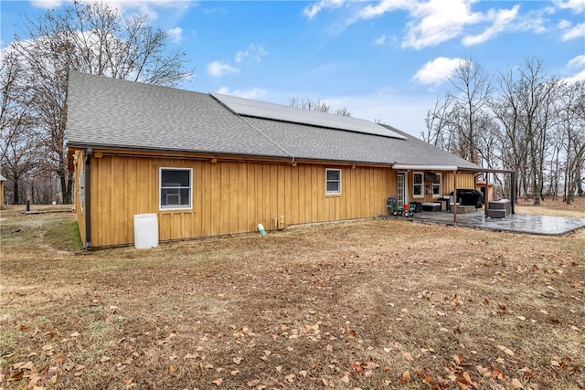 back of house with a patio area and a shingled roof