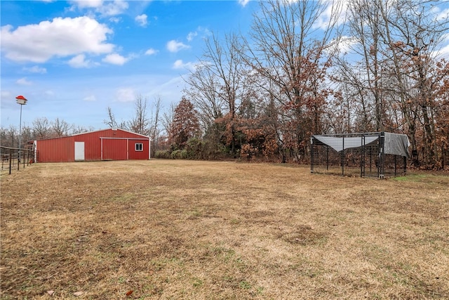 view of yard with an outbuilding, an outdoor structure, and a garage