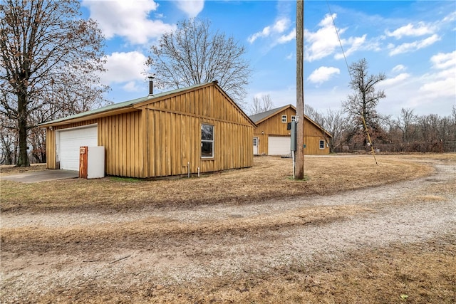 view of home's exterior featuring a garage and an outbuilding