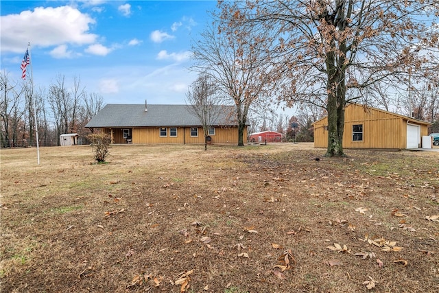 view of yard featuring a garage and a shed