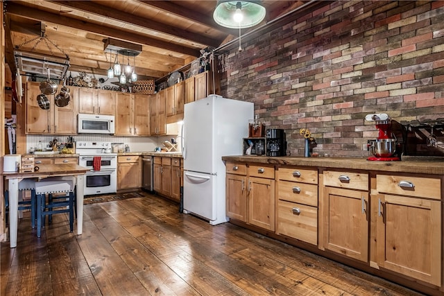 kitchen with brick wall, beam ceiling, white appliances, decorative light fixtures, and dark wood-style floors