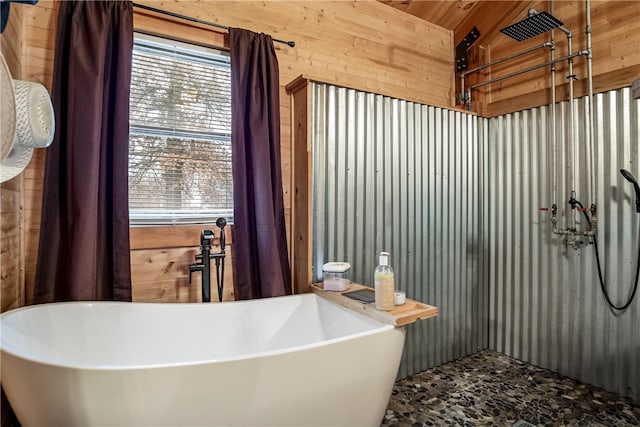 bathroom featuring a healthy amount of sunlight, wooden walls, a washtub, and wooden ceiling