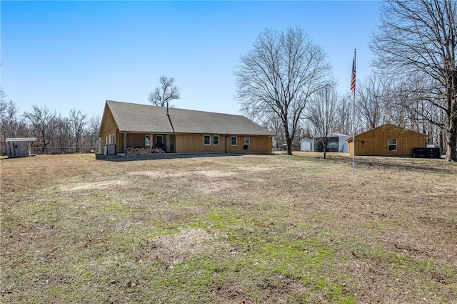 back of property featuring a yard