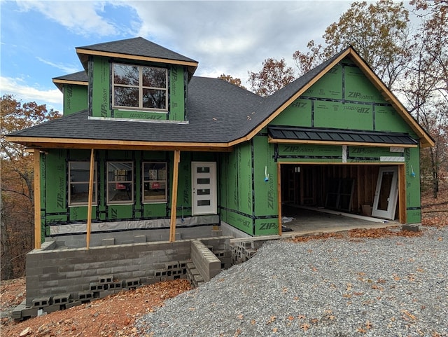 view of front of home with covered porch and a garage