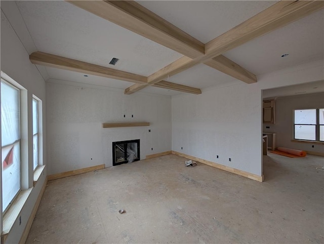 unfurnished living room featuring beam ceiling, visible vents, a fireplace, and baseboards