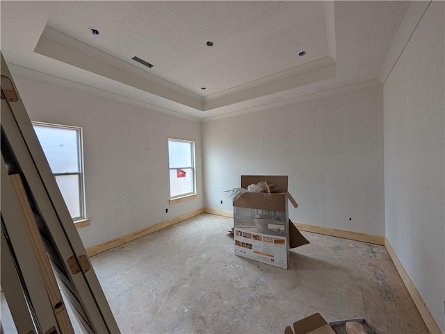 unfurnished bedroom featuring crown molding, a raised ceiling, visible vents, a textured ceiling, and baseboards