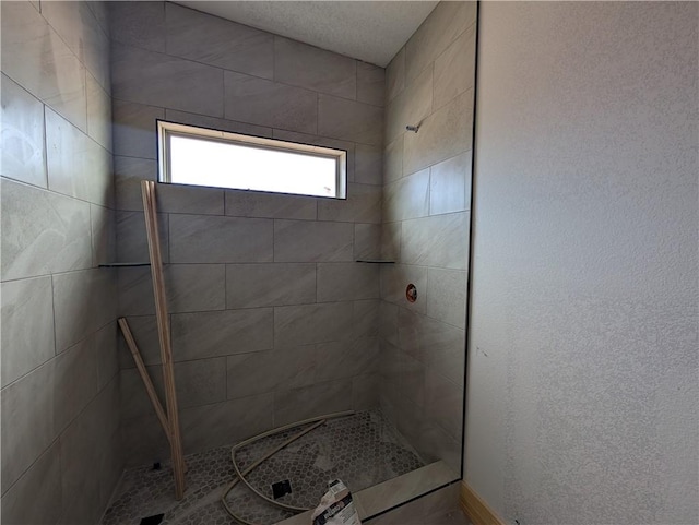 bathroom with tiled shower