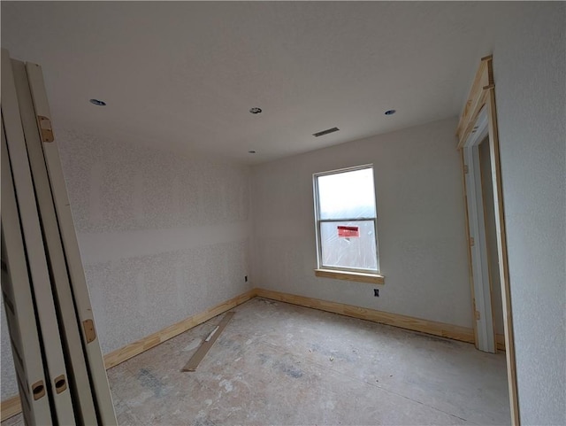 spare room with visible vents and baseboards